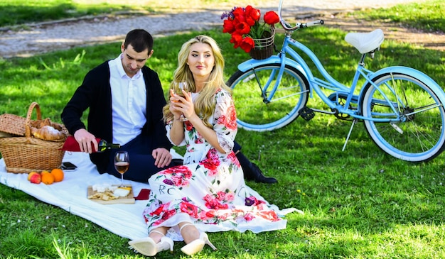 Zomerdag romantische picknick van verliefde familierelatie en vriendschap leuke zomervakantie meisje en man reizen samen verliefde paar drinken van wijn tijdens een romantisch diner in het park
