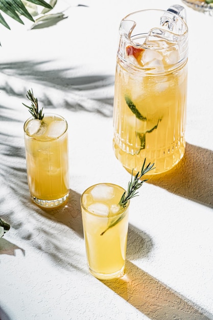 Zomerlimonade in kan en glas op tafel