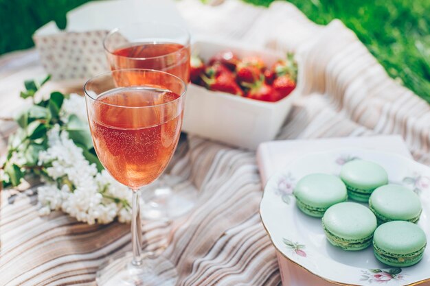 Zomerpicknick box met verse aardbei roze limonade dessert bitterkoekjes mand met lila bloemen