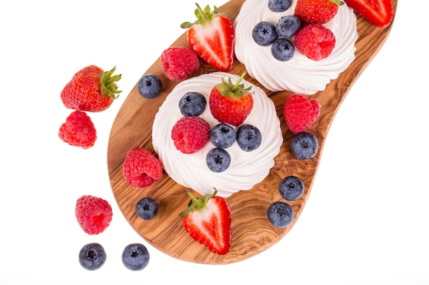 Zomerse fruitpavlova's op olijfhouten bord