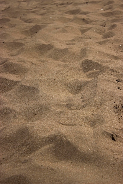 Foto zomerstrand vastgelegd tijdens een mooie dag close-up zandtextuur