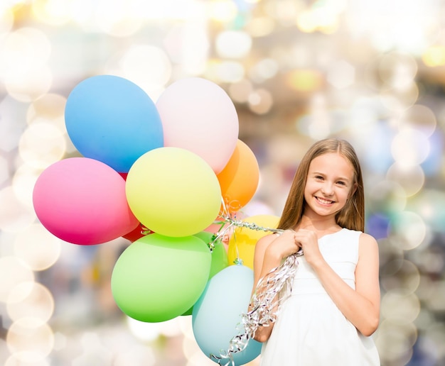 zomervakantie, feest, familie, kinderen en mensen concept - gelukkig meisje met kleurrijke ballonnen