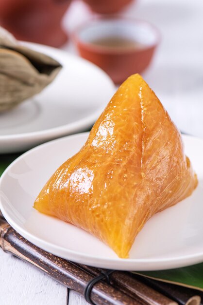 Zongzi Alkaline rice dumpling Traditional sweet Chinese crystal food on a plate to eat for Dragon Boat Duanwu Festival celebration concept close up