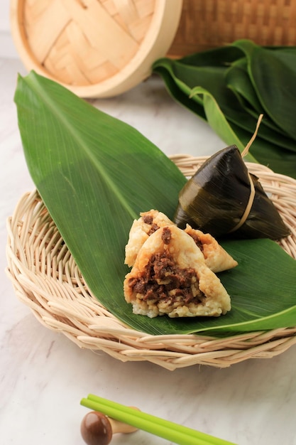 Zongzi or Bakcang. Chinese Savoury Sticky Rice Dumplings Wrapped with Bamboo Leaves
