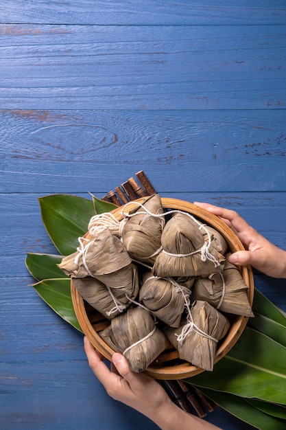 Zongzi dragon boat festival concept rice dumpling traditional\
chinese food on blue wooden background for duanwu festival top view\
flat lay design concept