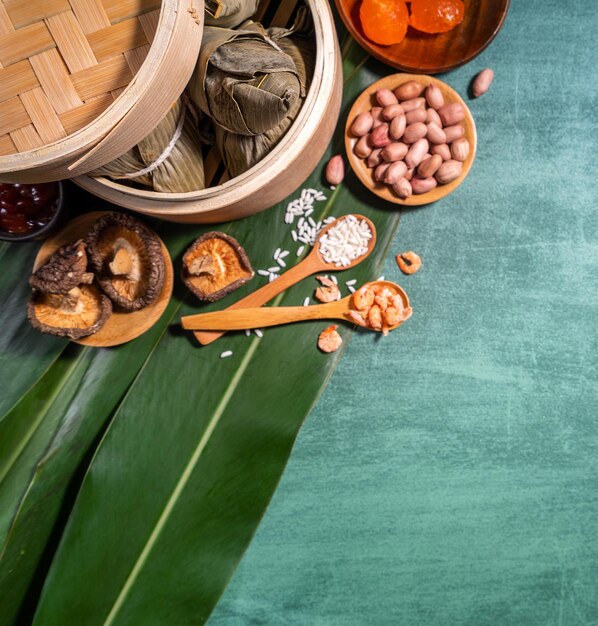 Zongzi steamed rice dumplings on green table background food in dragon boat festival duanwu concept close up copy space top view flat lay