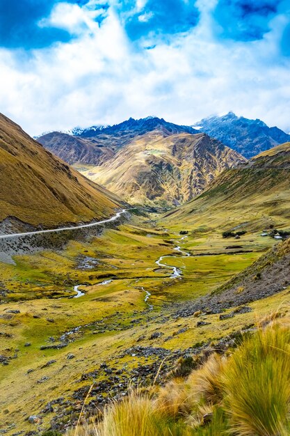 Zonneschijnmening van ruime groene vallei tussen rotsachtige hoge bergen in machupicchu