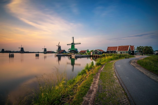 Zonsondergang boven boerderijen en windmolens van de Zaanse Schans in Nederland