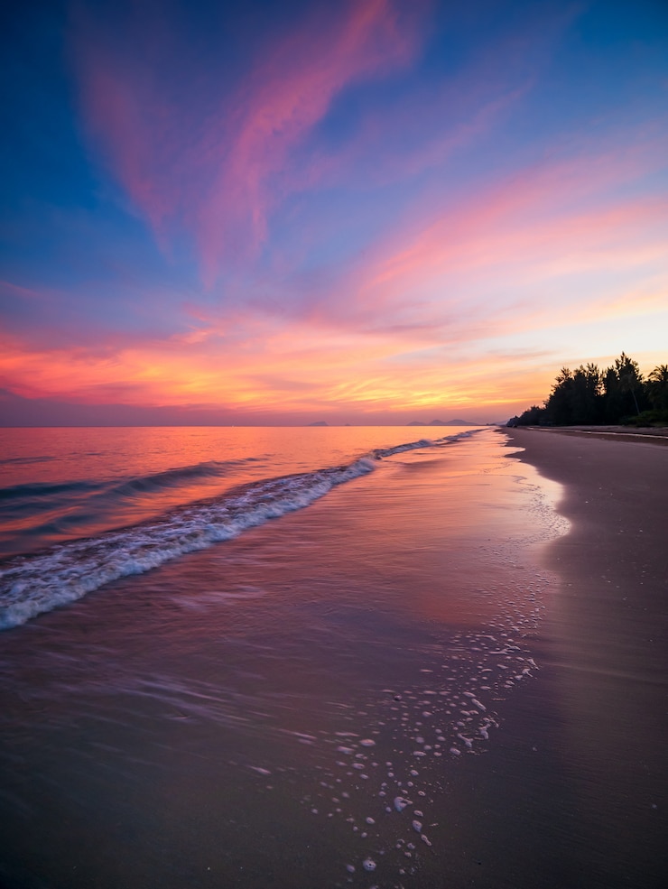 Foto zonsopgang met dramatische kleurenhemel over overzees en strand.