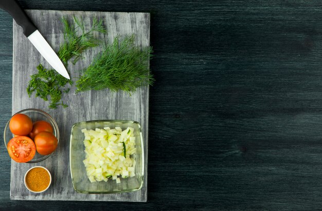 Zucchini in the background. Fried young sliced courgettes in a pan on a dark background. The view from the top. Copy space