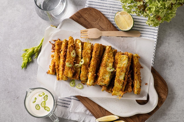 Zucchini baked in breading, diet appetizer on a light background, top view