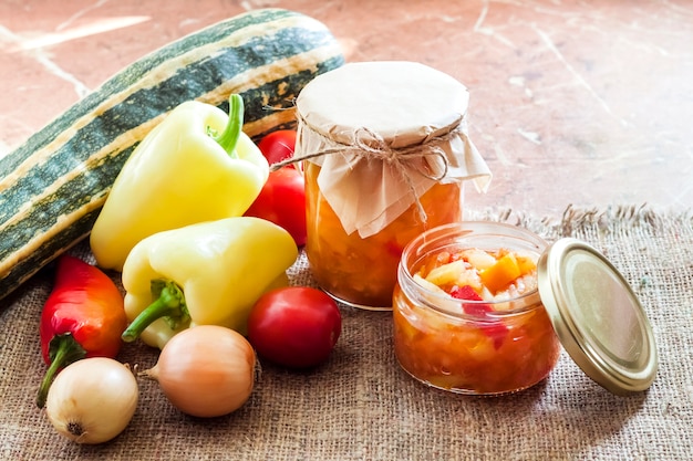 Zucchini and bell pepper salad in glass jar with ingredients