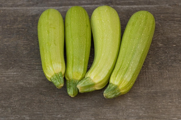 Zucchini benefits concept Zucchini on wooden background