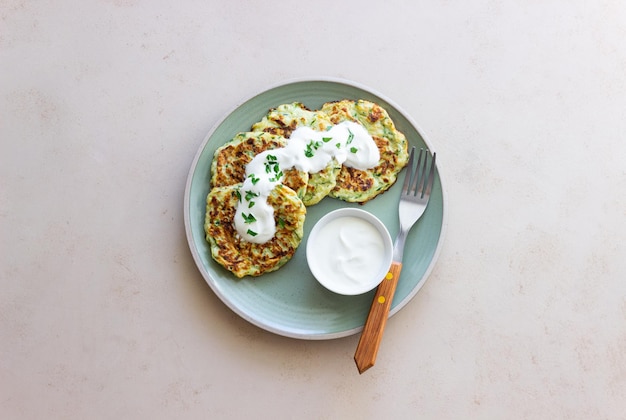 Zucchini fritters or pancakes with sour cream and herbs Healthy eating Vegetarian food