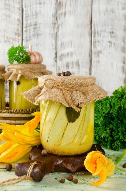 Zucchini preserve in glass jar on a wooden table