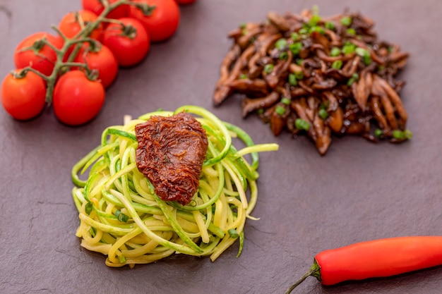 Zucchini spaghetti with dehydrated  and  dried tomatoes