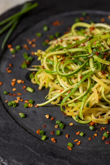 Zucchini spaghetti with dehydrated pepperoni pepper.