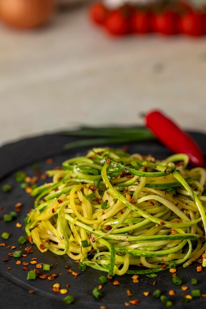 Zucchini spaghetti with dehydrated pepperoni pepper.