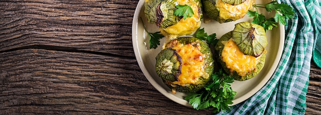 Zucchini stuffed with minced meat, cheese and green herbs. Baked in oven. Banner. 