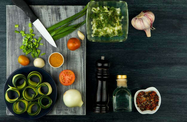 Zucchini in the table. Fried young sliced courgettes in a pan on a dark table. The view from the top. Copy space