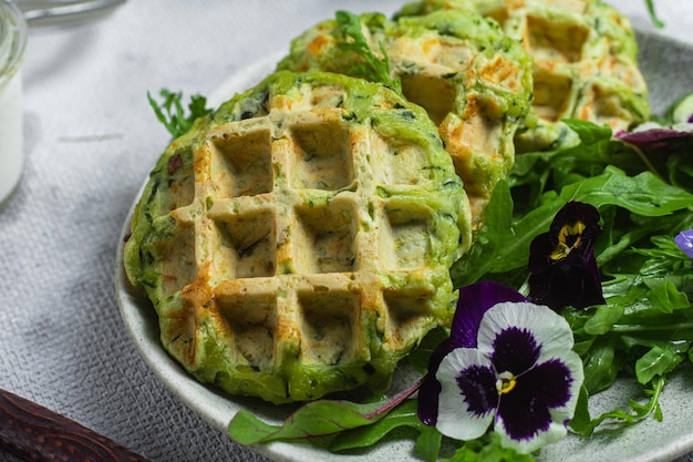 Zucchini waffles with arugula in a bowl