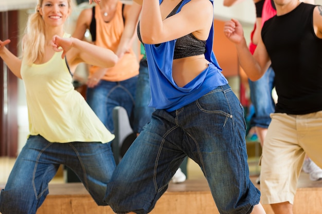 Zumba or Jazzdance - young people dancing in studio