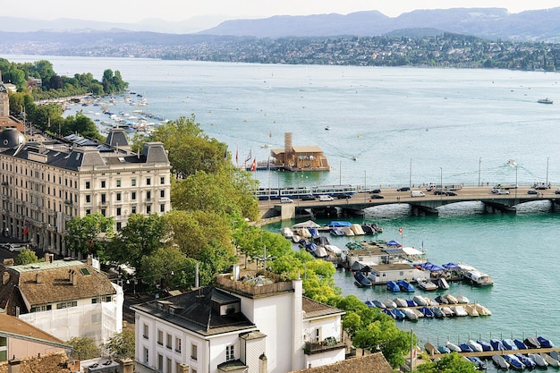 Zurich, Switzerland - September 2, 2016: Boats at Limmat River in Zurich old town, Switzerland. People on the background