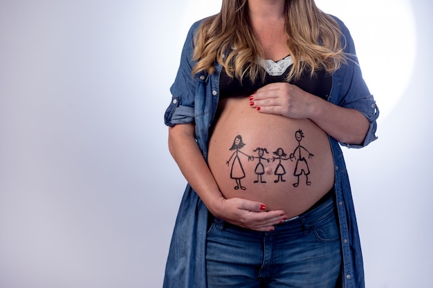 Zwangere vrouw met een familie die op haar buik trekt
