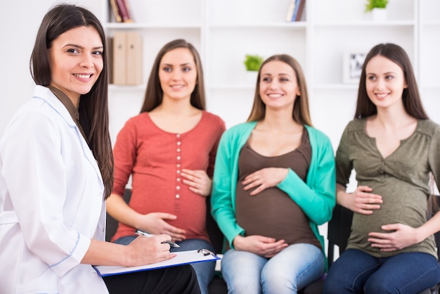 Zwangere vrouwen luisteren naar arts in prenatale klasse.