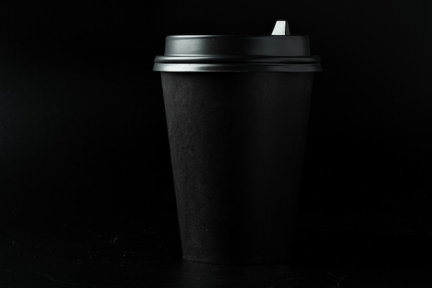 Zwart papier koffiekopje op donkere achtergrond
