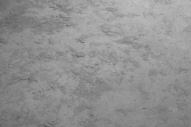 Foto zwart-witte achtergrond met een patroon van kleine steentjes en een plasje water