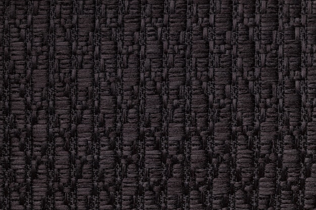 Zwarte gebreide wollen achtergrond met een patroon van zachte, wollige doek.