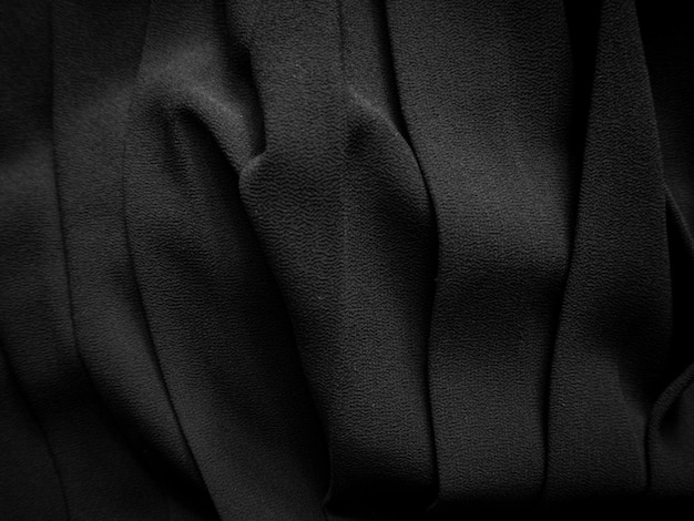 Zwarte geplooide stof Donkere kledingachtergrond