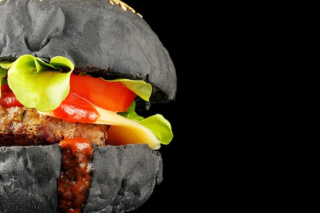 Zwarte hamburgerclose-up Hamburger met tomaten, groene uien en vleesplaats voor tekst om ruimte te bieden