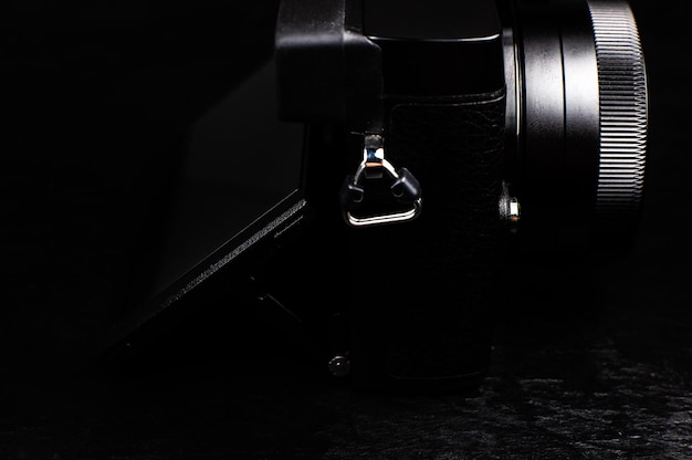 Zwarte moderne camera met lens op de zwarte achtergrond Close up