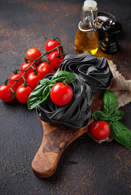 Zwarte ongekookte pasta met tomaat en basilicum