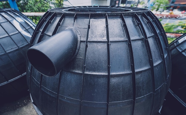 Zwarte plastic wateropslagtanks in het fabrieksdepot van de fabrikant