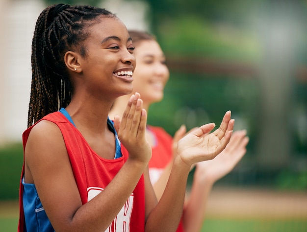 Zwarte sport-cheerleader en applaus voor team ter ondersteuning van motivatie of positieve houding in de buitenlucht Afro-Amerikaanse vrouw die in sportactiviteiten klapt, motiveert en aanmoedigt