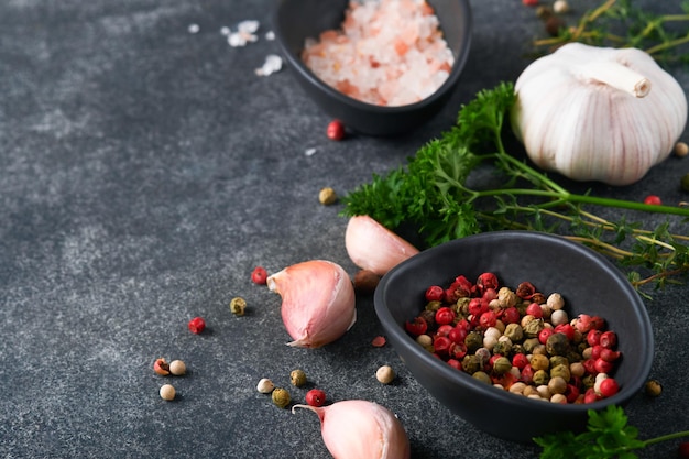 Zwarte voedsel koken achtergrond steen textuur met zeezout peper knoflook en peterselie abstracte voedsel achtergrond lege ruimte voor tekst kan worden gebruikt voor voedsel posters ontwerp van menu bovenaanzicht