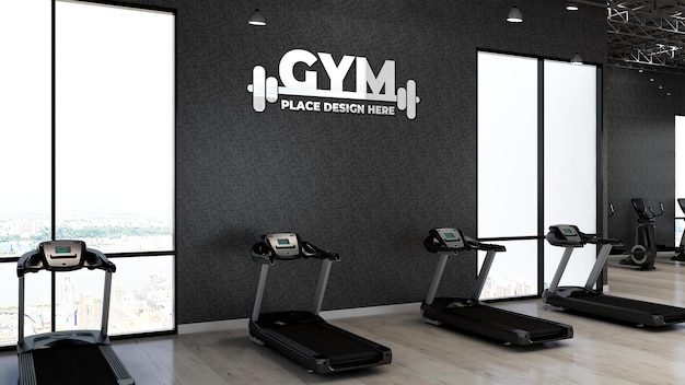 PSD 3d gym logo mockup in the fitness area with the black wall for athlete