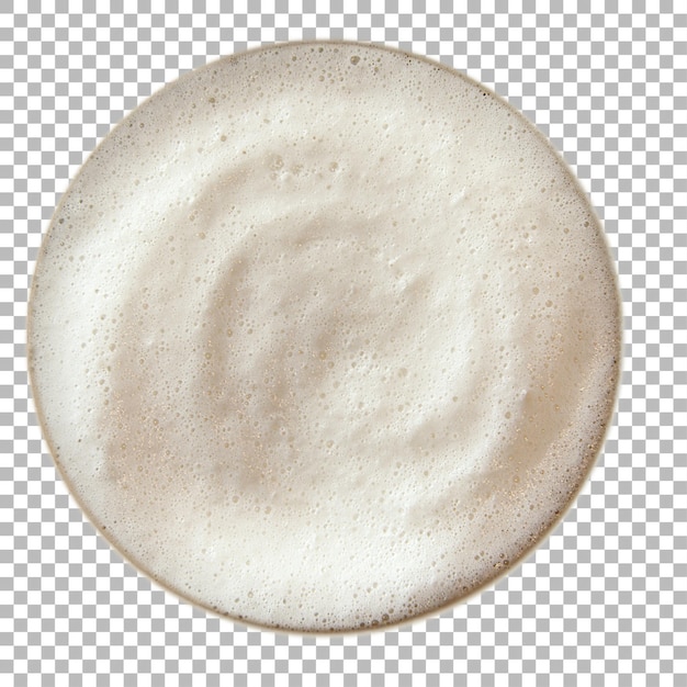 A frothy surface of a beverage likely coffee or beer displayed in a round cup