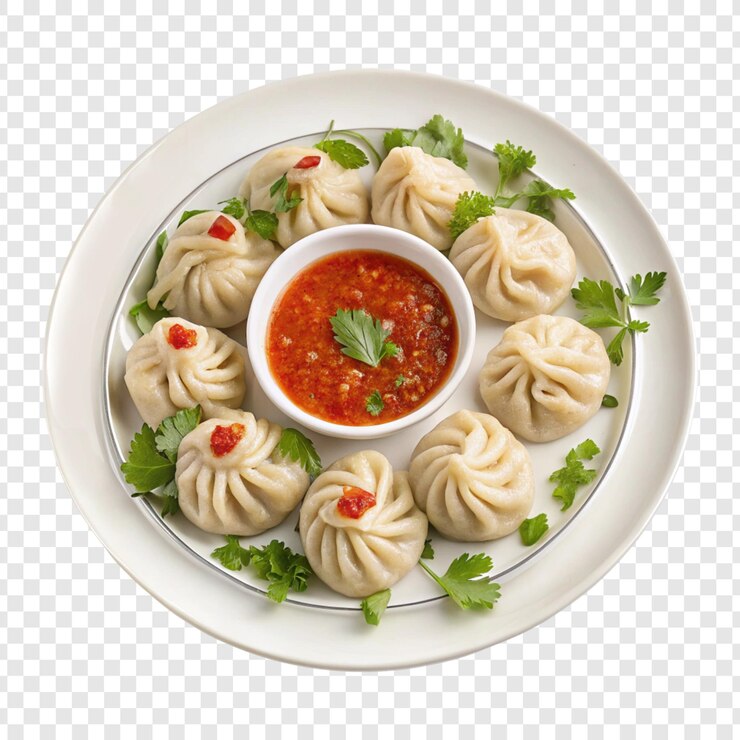 A plate of dumplings with a bowl of sauce on it
