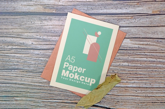 A5 paper greeting card mockup on wooden background