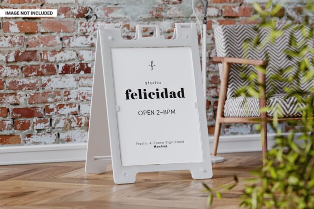 PSD advertising sandwich board sign near brick wall mockup