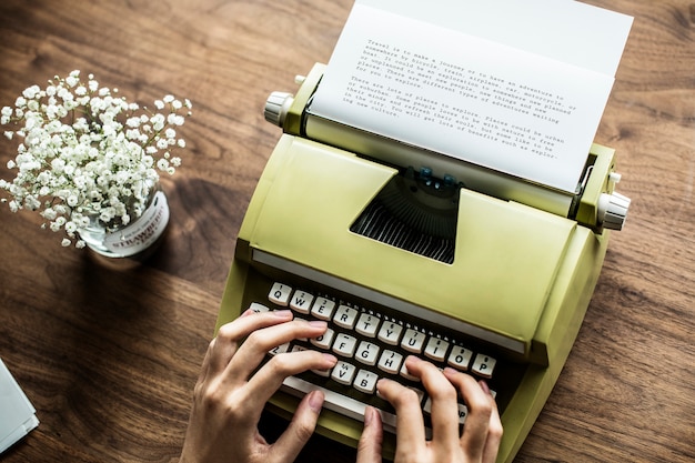 Aerial view a woman using a retro typewriter