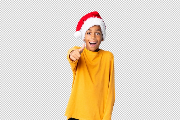 PSD african american boy with christmas hat surprised and pointing front