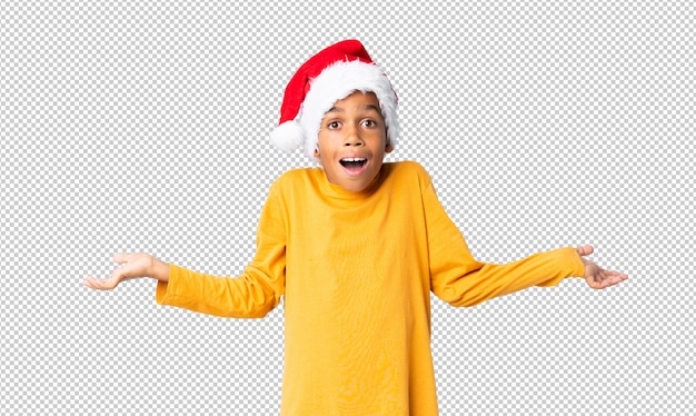 African american boy with christmas hat with shocked facial expression