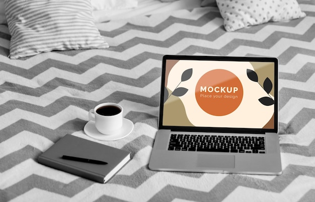 Agenda and mobile beside laptop