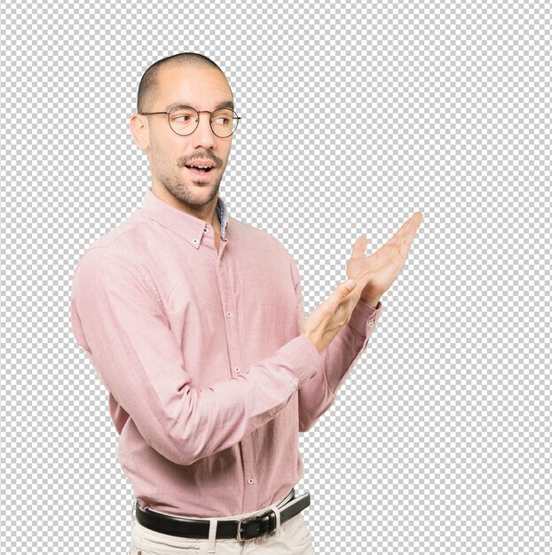 Amazed young man making a gesture of welcome