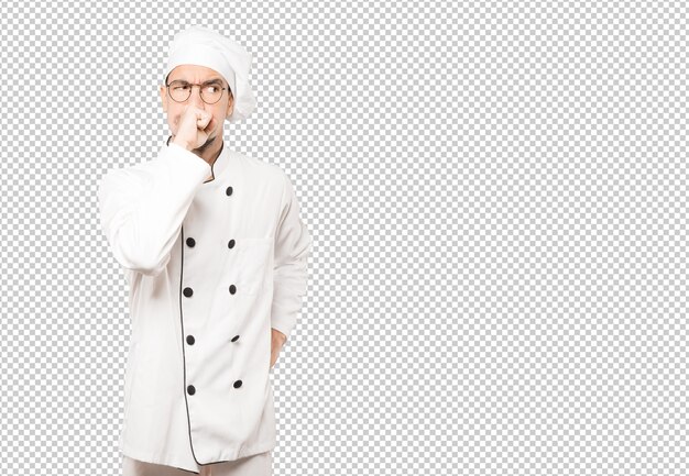 PSD angry young chef posing against background